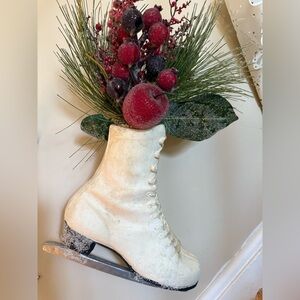 White lace ice skate Christmas ornament with greenery and red berries.